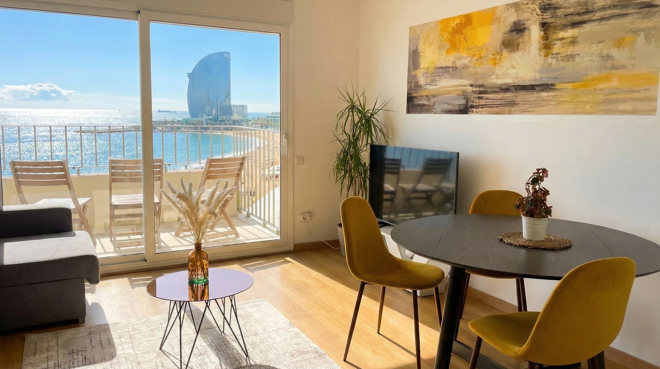 The living room and dining table, with the balcony, the beach and the W Hotel through the window