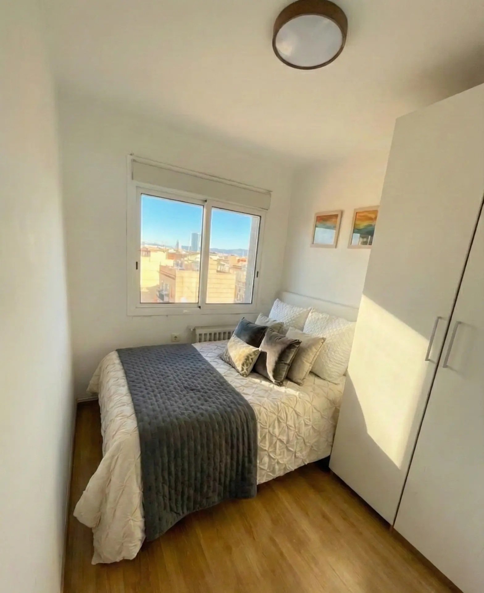 Bedroom two, with a full-height wardrobe and city view
